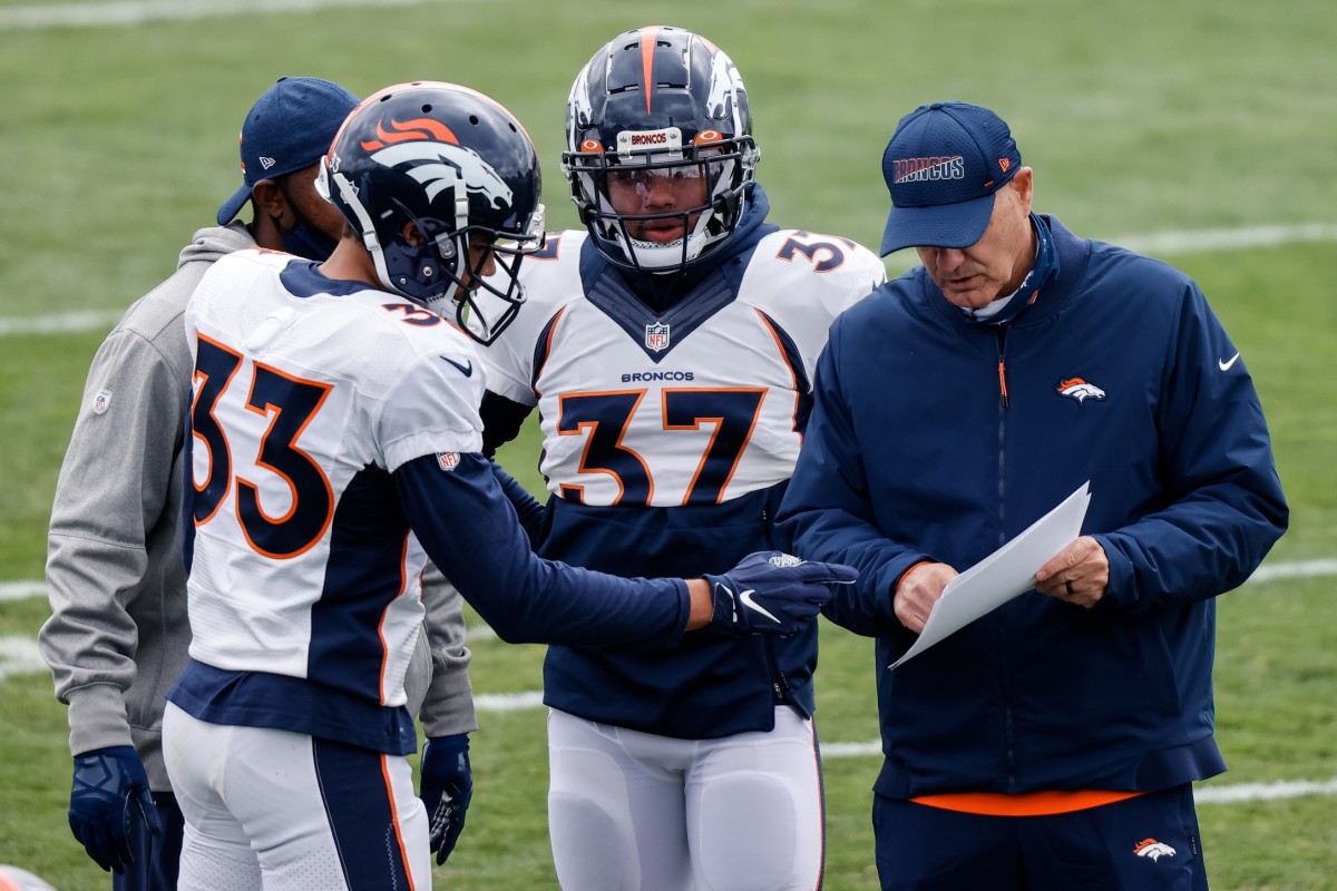 Denver Broncos defensive coordinator Ed Donatell with safety Alijah Holder (33) and safety P.J. Locke (37) during practice at UCHealth Training Center.