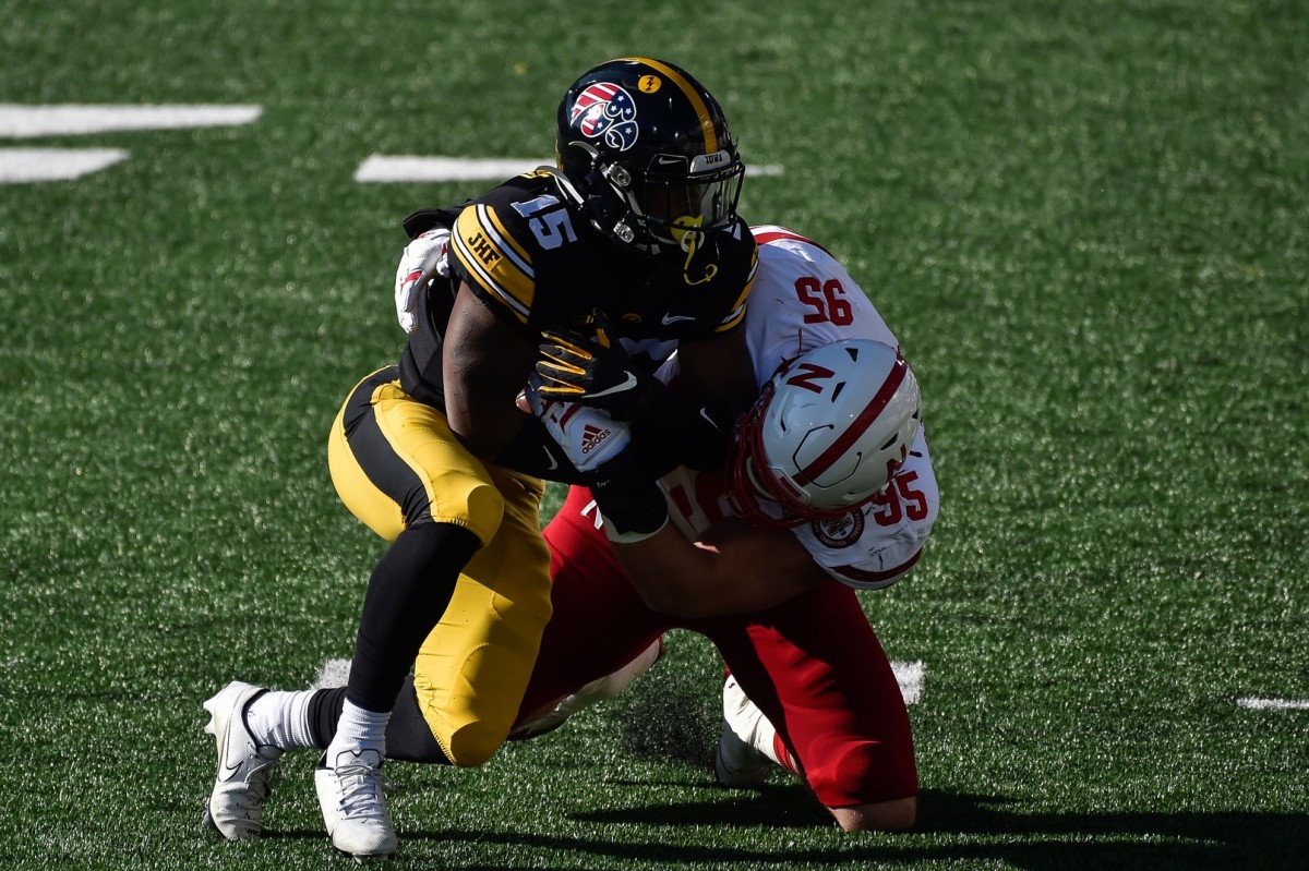 Iowa running back Tyler Goodson (15) is tackled by Nebraska's Ben Stille (95) during the first quarter at Kinnick Stadium. (Jeffrey Becker-USA TODAY Sports)