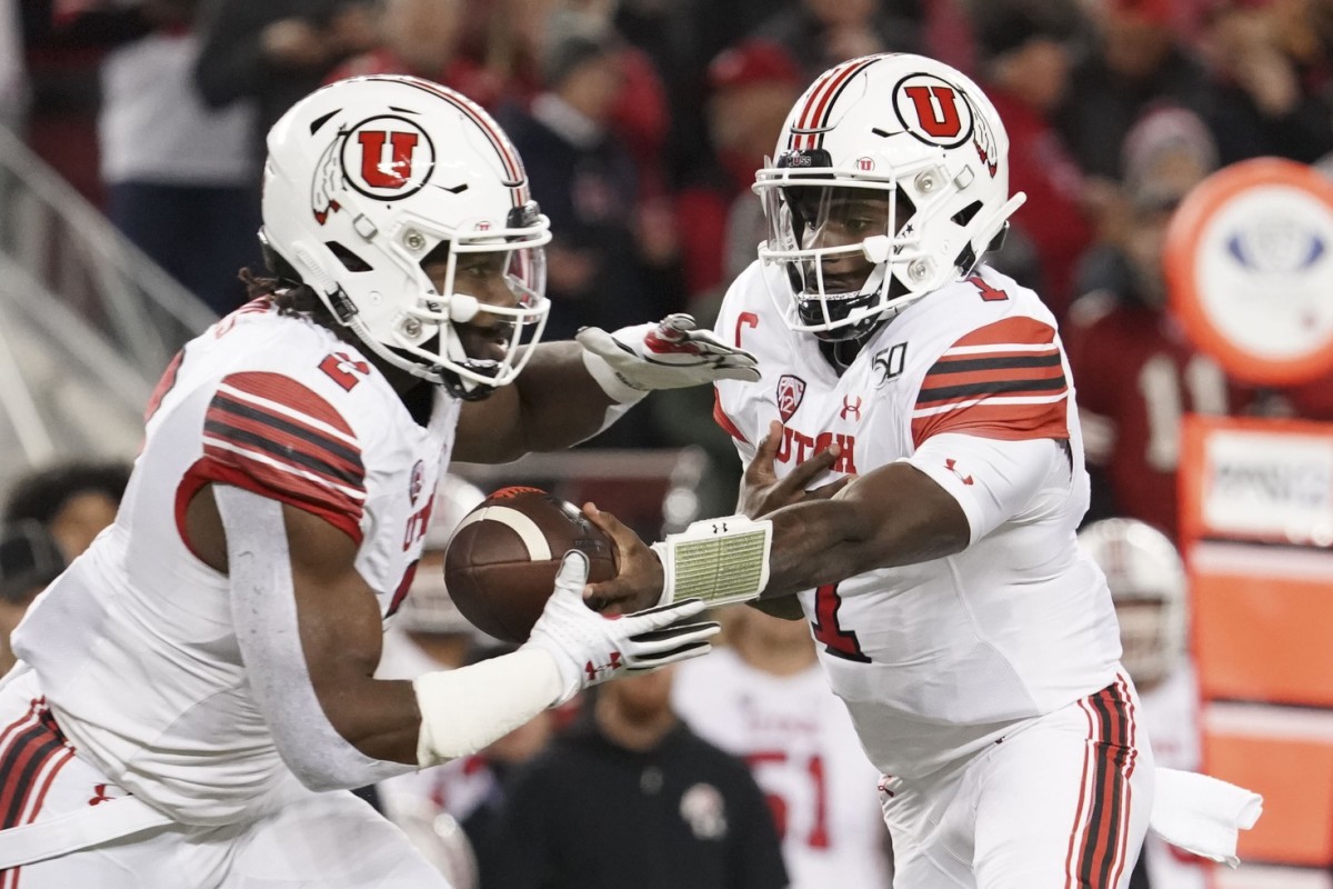 December 6, 2019; Santa Clara, CA, USA; Utah Utes quarterback Tyler Huntley (1) hands the football off to running back Zack Moss (2) against the Oregon Ducks during the first quarter at Levi's Stadium.