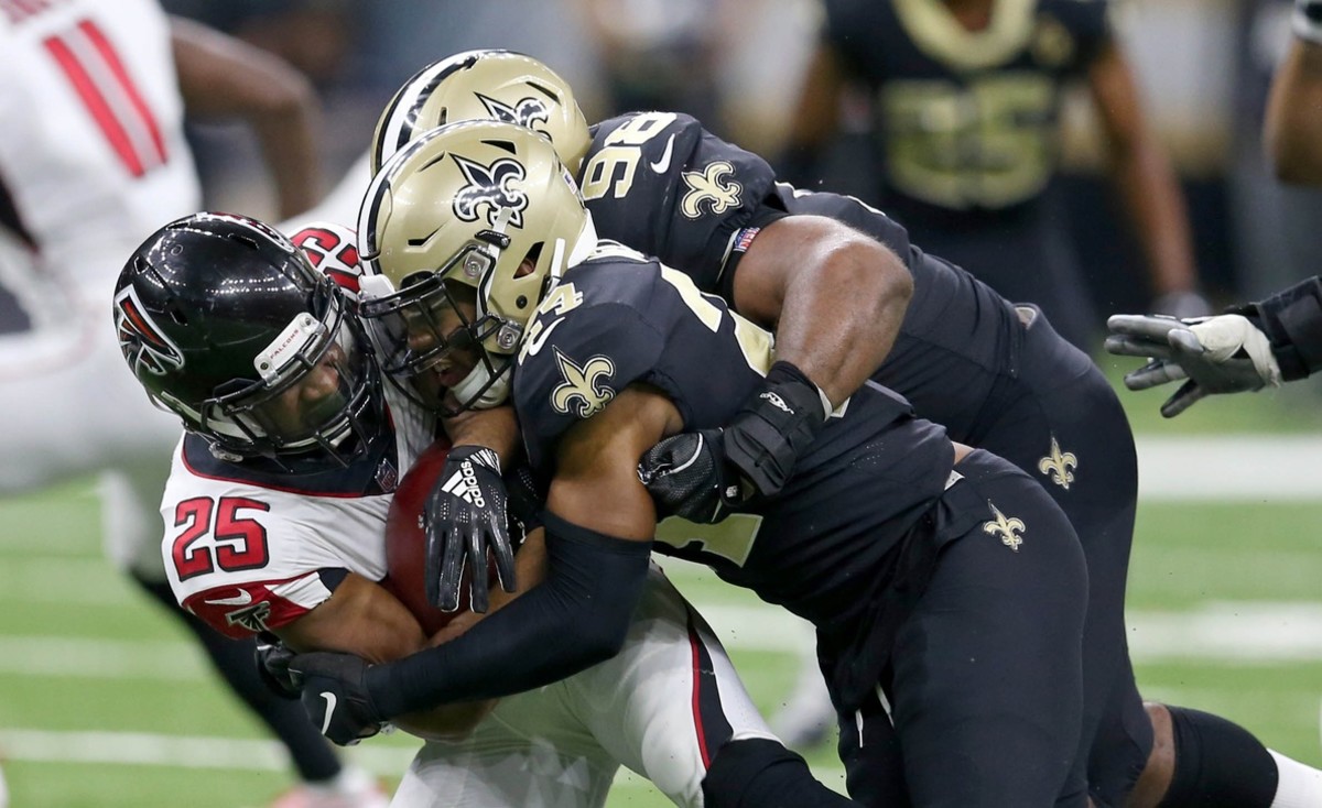 Nov 22, 2018; New Orleans, LA, USA; Atlanta Falcons running back Ito Smith (25) is tackled by New Orleans Saints defensive tackle Sheldon Rankins (98) in the second half at the Mercedes-Benz Superdome. Mandatory Credit: Chuck Cook-USA TODAY 
