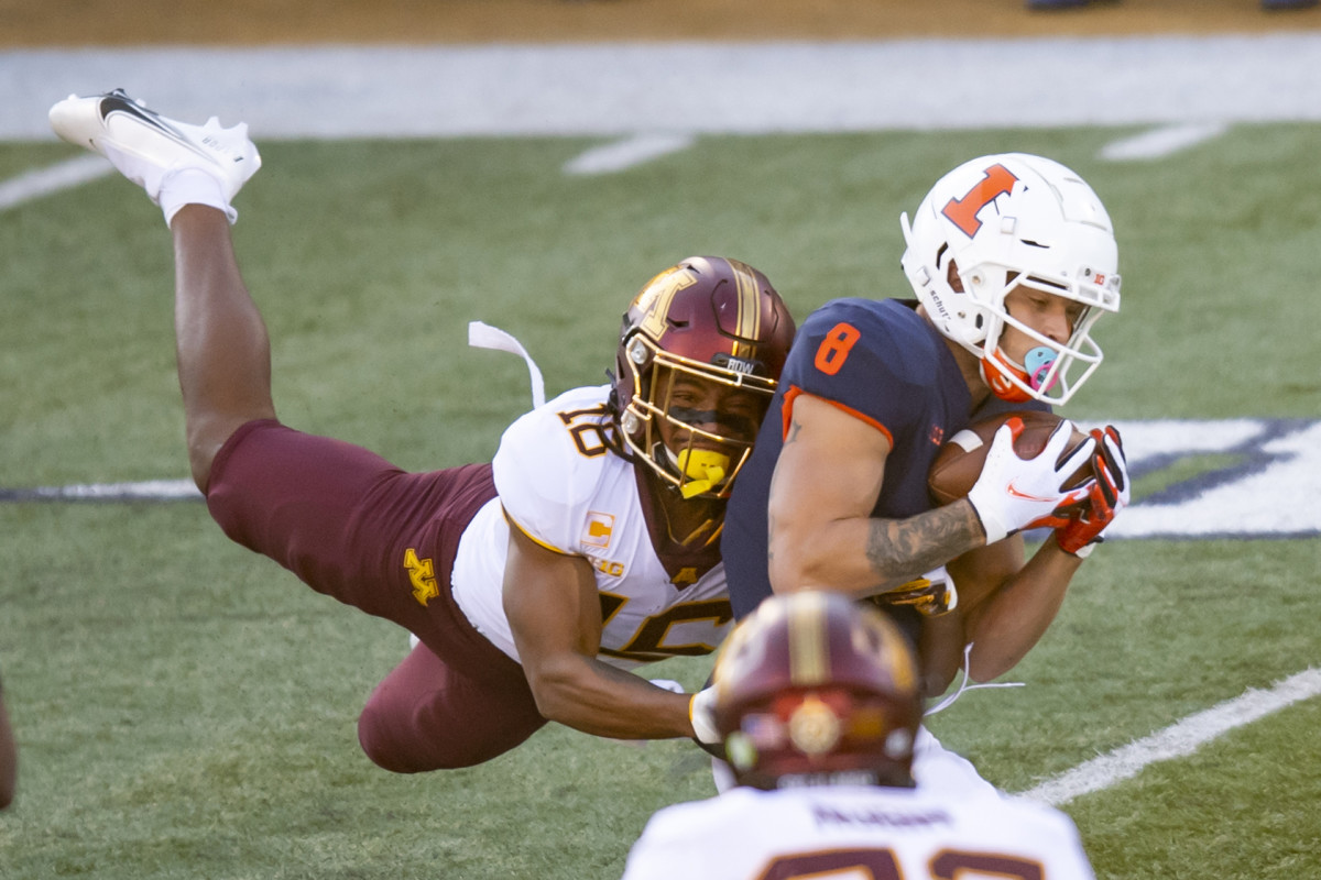 Minnesota Golden Gophers defensive lineman Micah Dew-Treadway (18) tackles Illinois Fighting Illini wide receiver Casey Washington (8) during the first half of the 2020 game at Memorial Stadium.