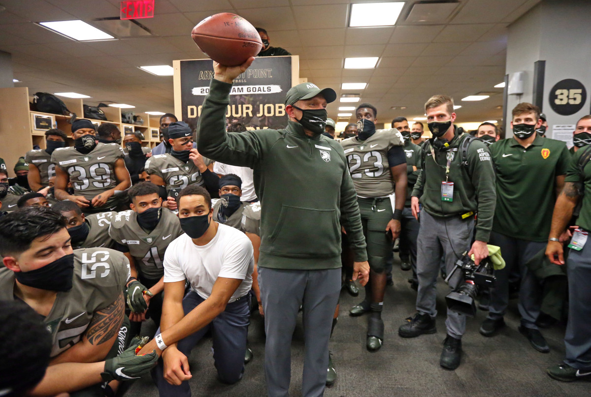 Army Black Knights head coach Jeff Monken holds up a football while celebrating with his players after a 15-0 win over Navy in the Army-Navy game at Michie Stadium.