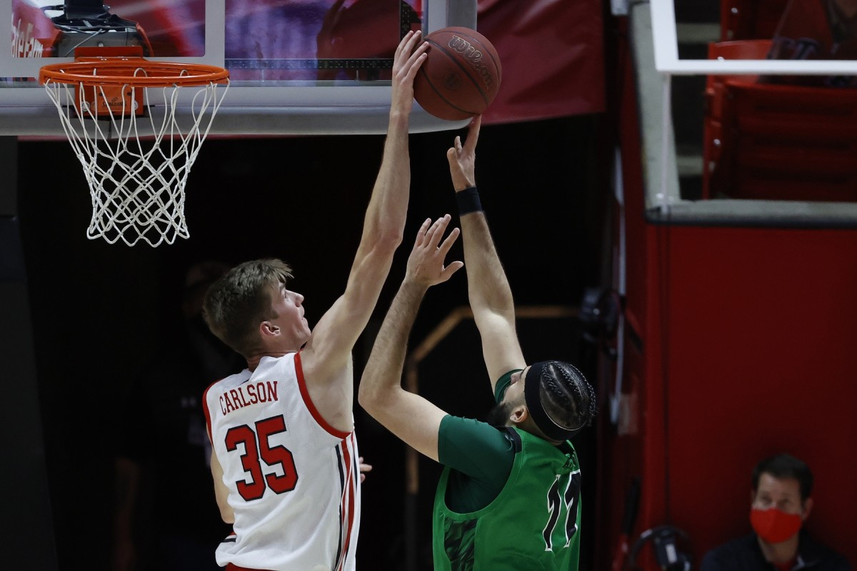 Dec 15, 2020; Salt Lake City, Utah, USA; Utah Utes center Branden Carlson (35) blocks a shot by Utah Valley Wolverines center Fardaws Aimaq (11) in the second half at the Jon M. Huntsman Center.