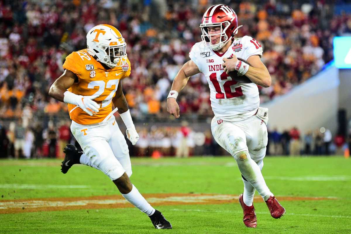 Indiana quarterback Peyton Ramsey (12) is chased by Tennessee defensive back Jaylen McCollough (22) during the Gator Bowl game between Tennessee and Indiana at TIAA Bank Field in Jacksonville, Fla.