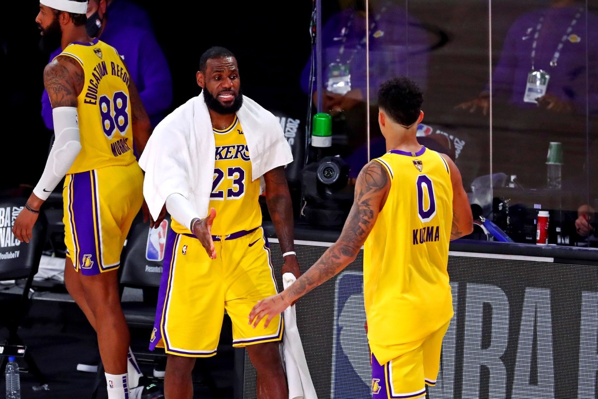 Sep 30, 2020; Orlando, Florida, USA; Los Angeles Lakers forward LeBron James (23) celebrates with forward Kyle Kuzma (0) during the fourth quarter against the Miami Heat in game one of the 2020 NBA Finals at AdventHealth Arena.