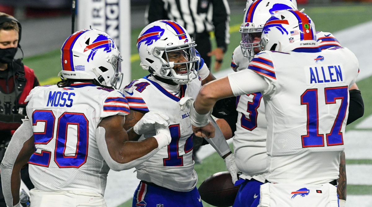 Buffalo Bills wide receiver Stefon Diggs celebrates with quarterback Josh Allen and running back Zack Moss after scoring a touchdown against the New England Patriots during the second half at Gillette Stadium.