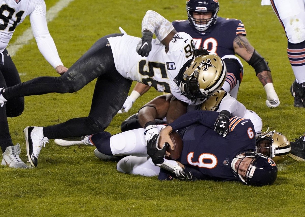 Nov 1, 2020; Chicago, Illinois, USA; New Orleans Saints outside linebacker Demario Davis (56) sacks Chicago Bears quarterback Nick Foles (9) during the third quarter at Soldier Field. Mandatory Credit: Mike Dinovo-USA TODAY Sports