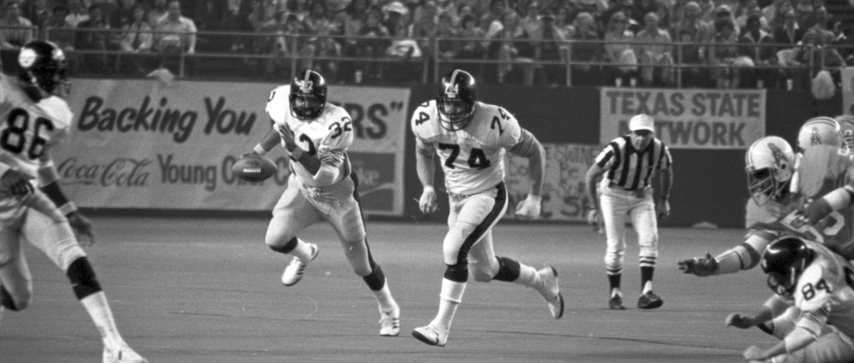 Ray Pinney escorts Franco Harris upfield against the Houston Oilers.