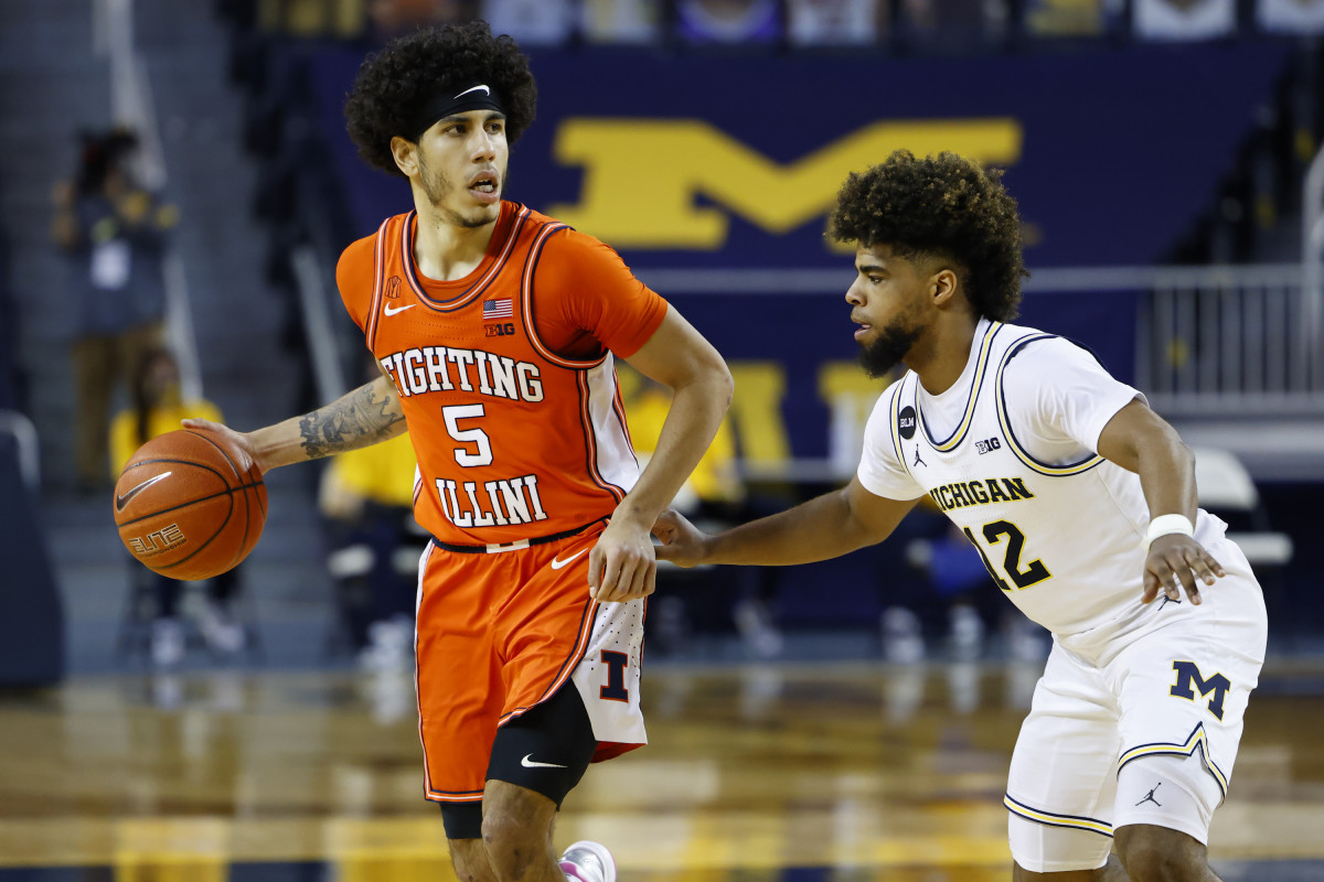 Illinois Fighting Illini guard Andre Curbelo (5) dribbles defended by Michigan Wolverines guard Mike Smith (12) in the second half at Crisler Center.