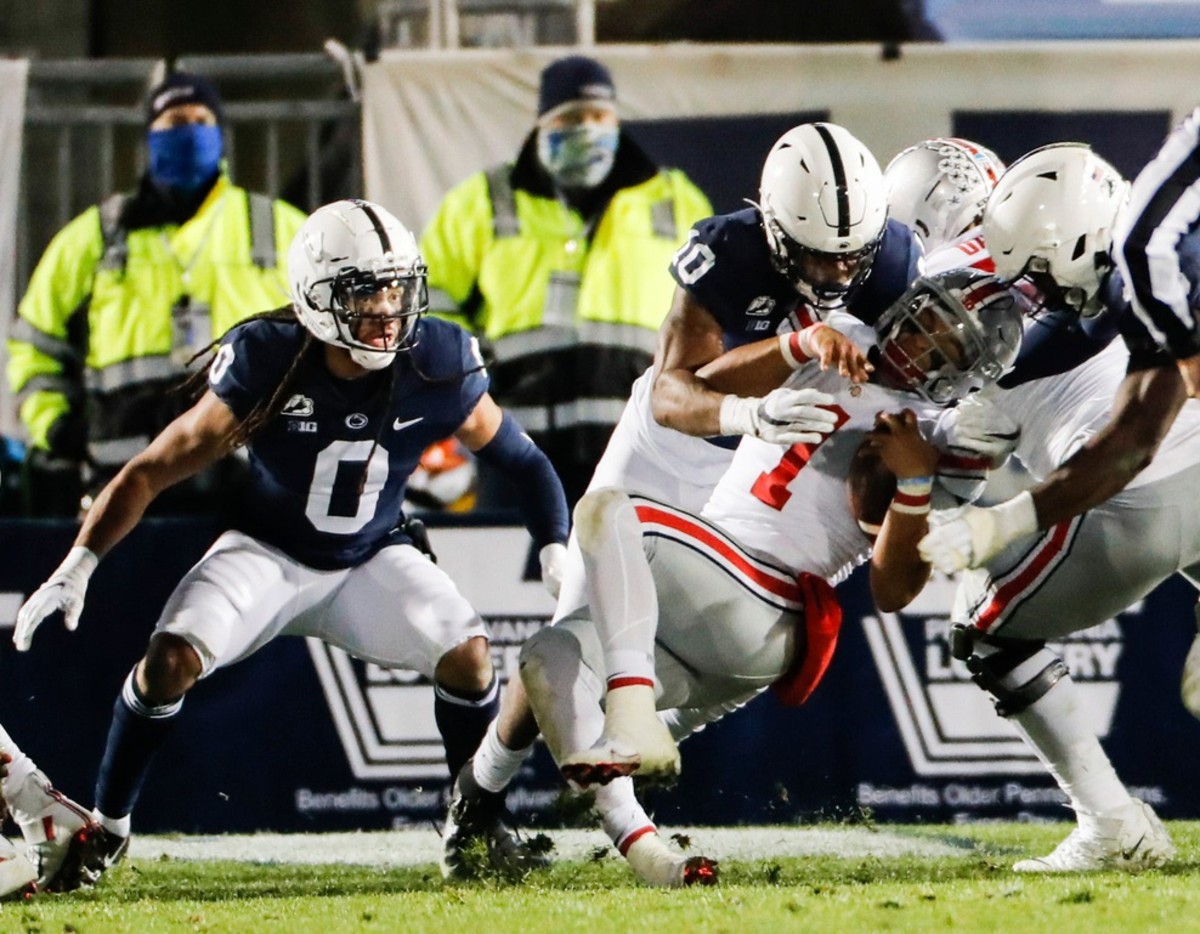 Ohio State Buckeyes quarterback Justin Fields (1) fights for yardage at the goal line as Penn State Nittany Lions linebacker Lance Dixon (10) and Penn State Nittany Lions defensive end Jayson Oweh (28) defend during the fourth quarter of an NCAA football game at Beaver Stadium in University Park, Pa. on Saturday, Oct. 31, 2020. Ohio State Faces Penn State In Happy Valley