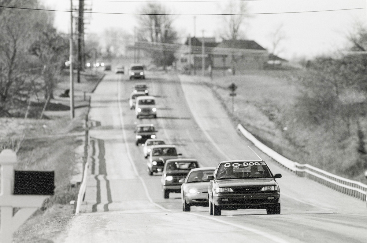 A line of cars drives to a Batesville basketball game in 1997.