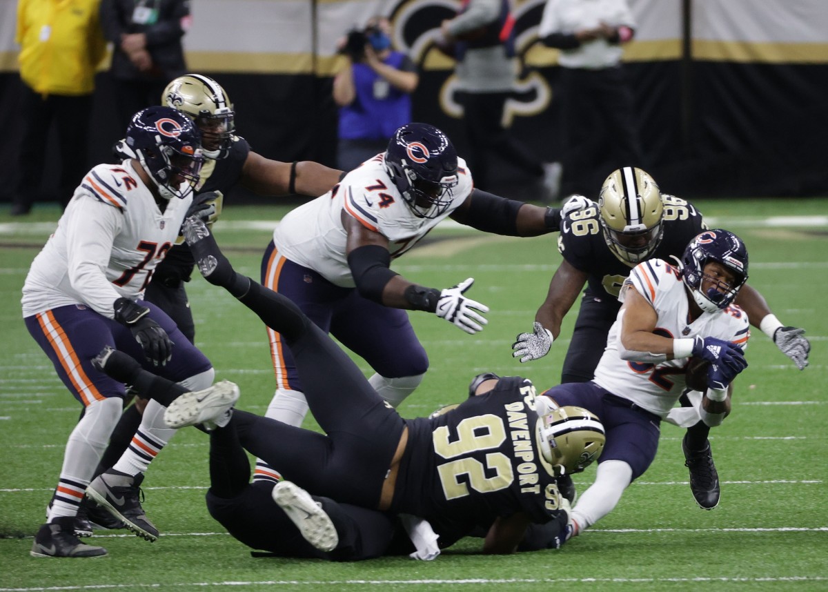 Jan 10, 2021; New Orleans, Louisiana, USA; Chicago running back David Montgomery (32) is brought down by Saints defensive ends Marcus Davenport (92) and Carl Granderson (96). Mandatory Credit: Derick E. Hingle-USA TODAY 