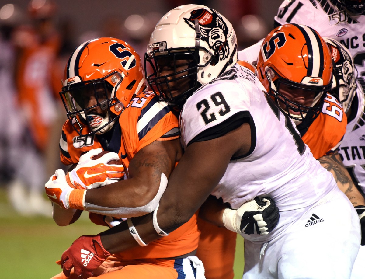 Oct 10, 2019; Raleigh, NC, USA; Syracuse running back Abdul Adams (23) is tackled by North Carolina State defensive tackle Alim McNeill (29). Mandatory Credit: Rob Kinnan-USA TODAY Sports