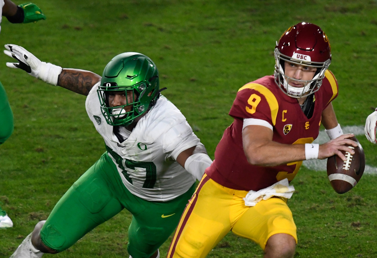 Brandon Dorlus (97) chases down USC quarterback Kedon Slovis (9) in the 2020 Pac-12 Championship Game.