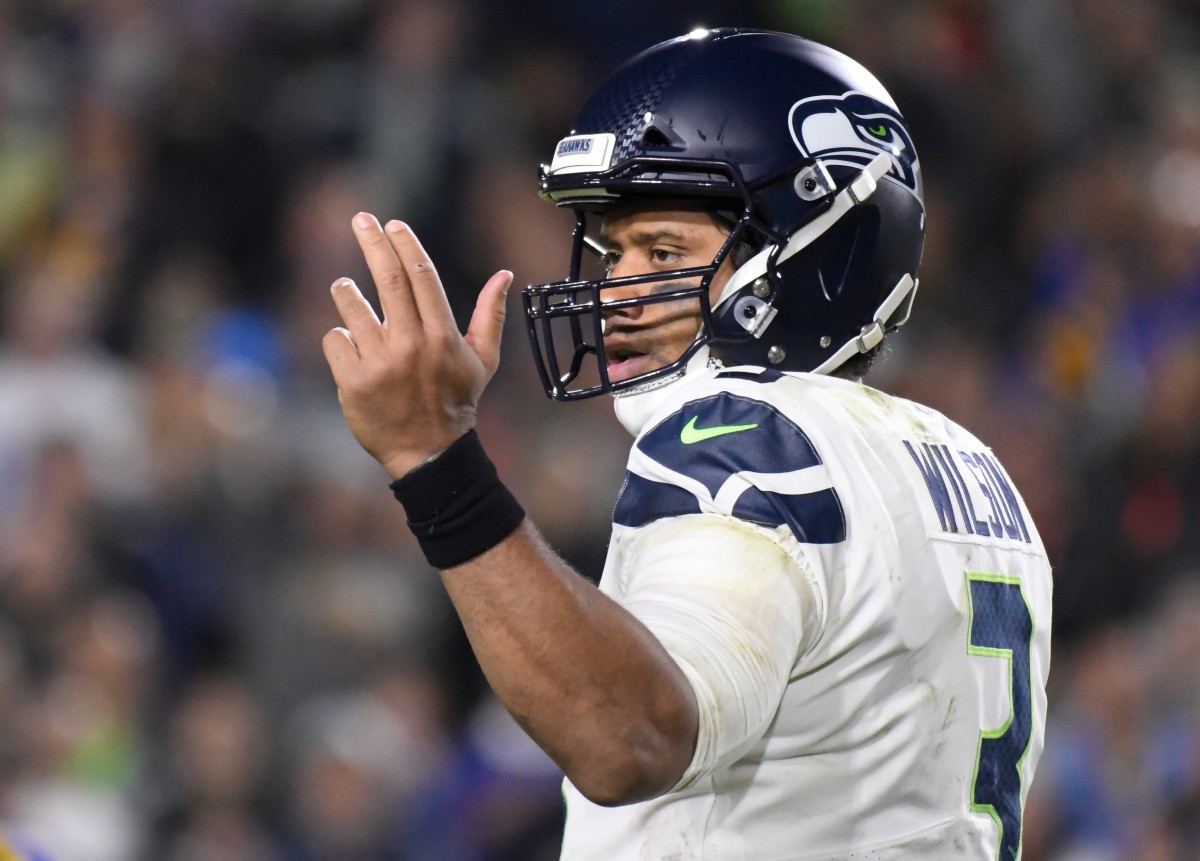 Seattle Seahawks mascot, Blitz, console Seattle Seahawks quarterback  Russell Wilson (3) as he departs the field after their 31-34 loss to the  Arizona Cardinals at CenturyLink Field in Seattle, Washington on December