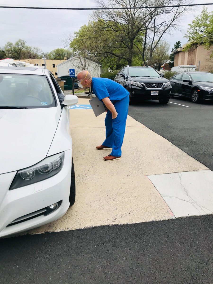 John Tabacco, a team doctor for Washington, is now doing curbside check-ups of people who drive up with potential COVID-19 symptoms.