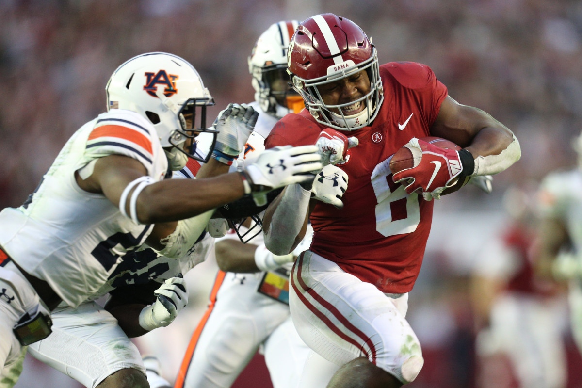 Alabama running back Josh Jacobs poses with his new team jersey