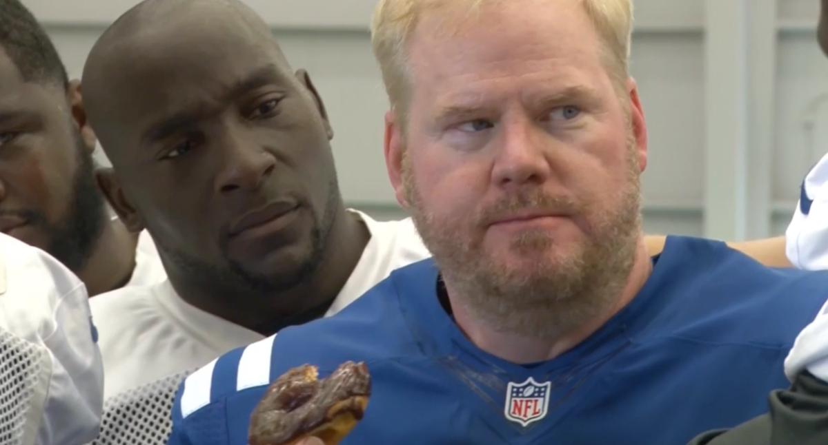 Stand-up comedian Jim Gaffigan (right) munches on a donut during a 2014 video in which he's on the Indianapolis Colts camp roster before being cut. The donut munching got the attention of Colts star pass rusher Robert Mathis (left).