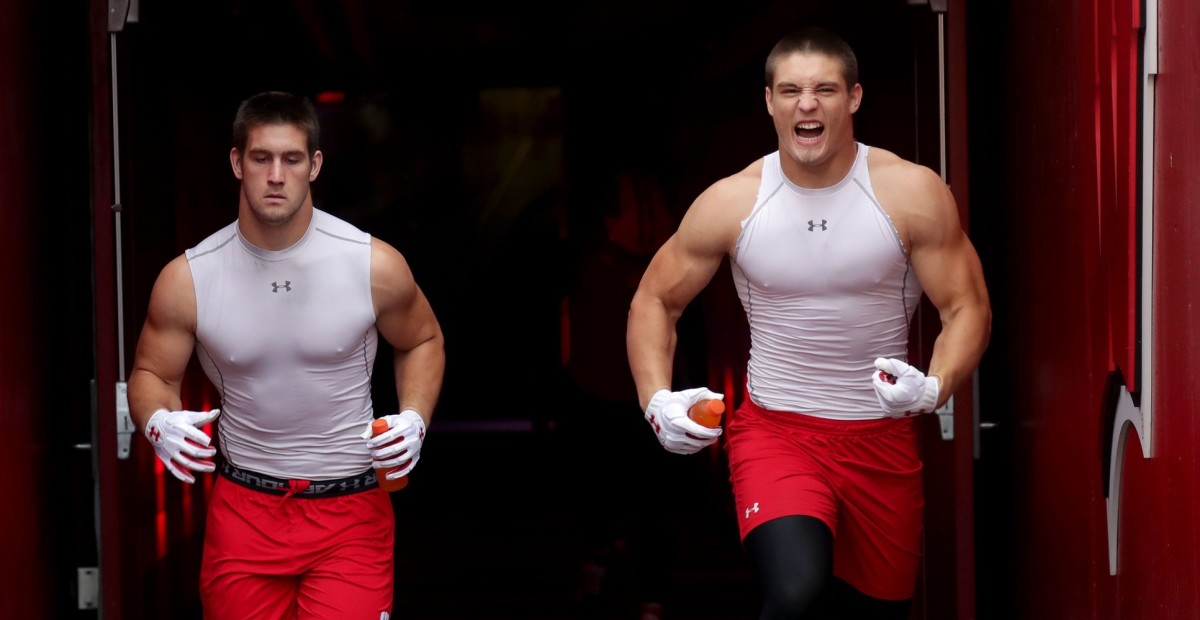 Ex-Badger Leo Chenal climbs parade bus during Super Bowl celebration