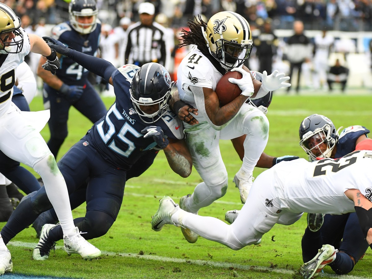 Dec 22, 2019; Nashville, Tennessee, USA; New Orleans Saints running back Alvin Kamara (41) scores as he is hit by Tennessee Titans inside linebacker Jayon Brown (55) during the second half at Nissan Stadium. Mandatory Credit: Christopher Hanewinckel-USA TODAY Sports