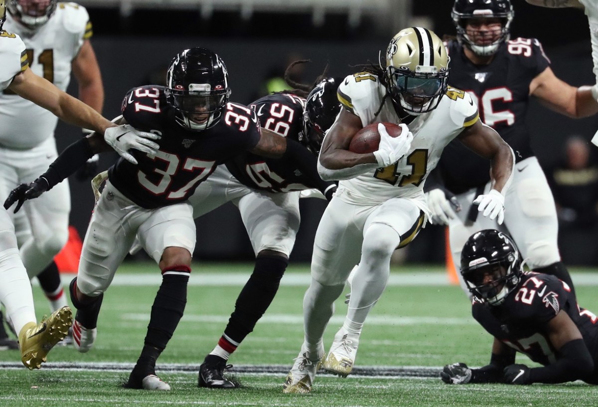 Nov 28, 2019; Atlanta, GA, USA; New Orleans Saints running back Alvin Kamara (41) runs against Atlanta Falcons free safety Ricardo Allen (37), outside linebacker De'Vondre Campbell (59) and strong safety Damontae Kazee (27) in the second half at Mercedes-Benz Stadium. Mandatory Credit: Jason Getz-USA TODAY Sports