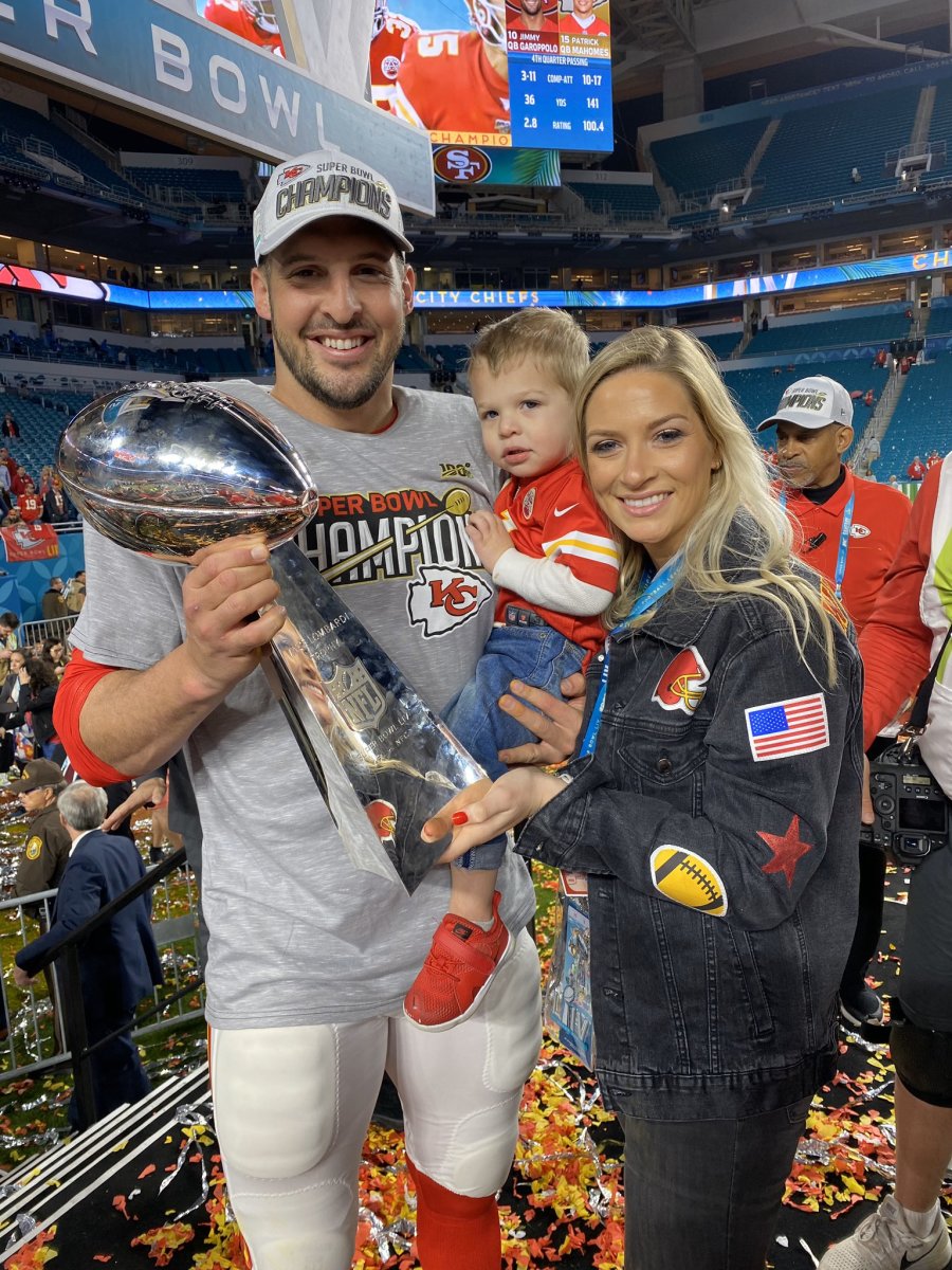 James Winchester, son Jase and wife Emily pose with the Vince Lombardi Trophy.