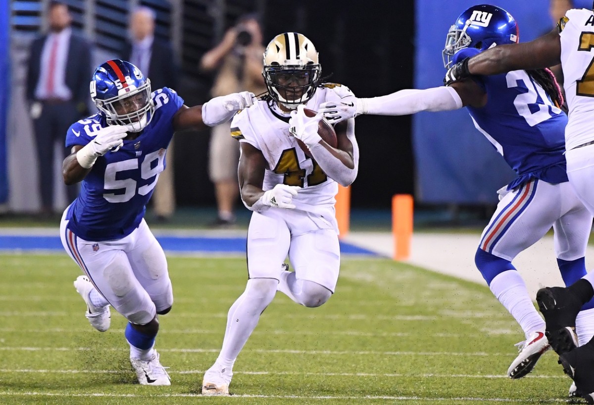 New Orleans Saints running back Alvin Kamara (41) carries for a first down past Giants linebacker Lorenzo Carter (59). Mandatory Credit: Robert Deutsch-USA TODAY Sports