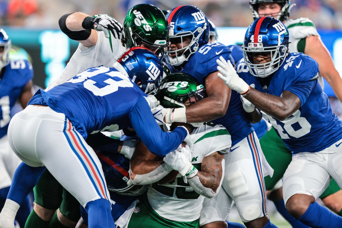 Jets running back Ty Johnson (25) is tackled by New York Giants linebackers Trent Harris (93) and Tae Crowder (48). Mandatory Credit: Vincent Carchietta-USA TODAY 