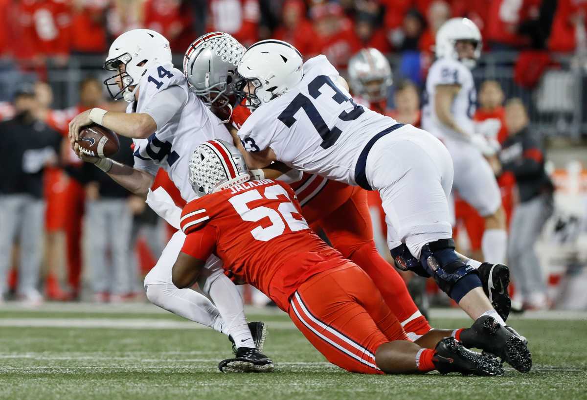 Penn State quarterback Sean Clifford is sacked by Ohio State's Antwuan Jackson (52) and Palaie Gaoteote. (Adam Cairns/Columbus Dispatch)