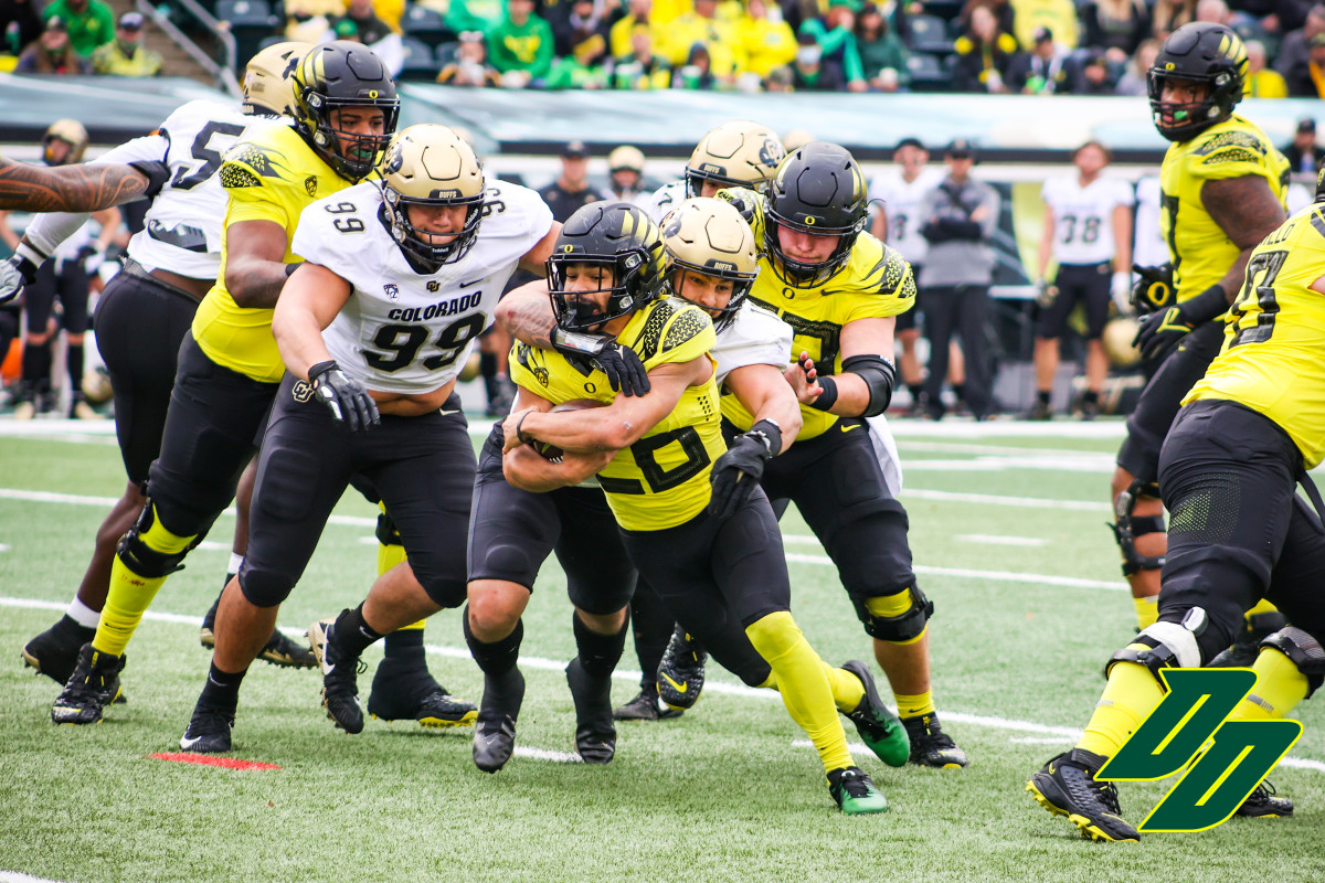 Travis Dye runs through multiple Colorado defenders