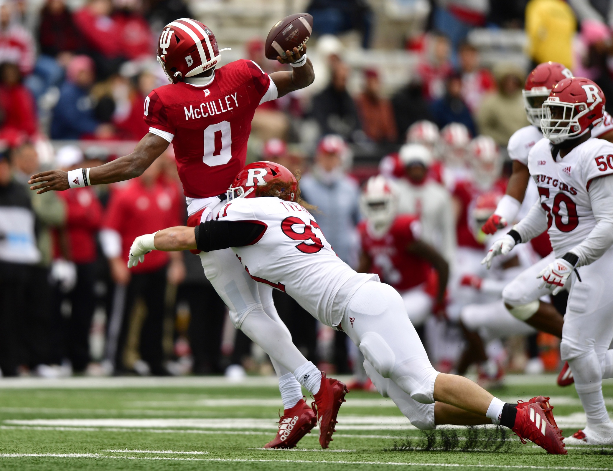 Indiana quarterback Donaven McCulley (0) barely gets off a pass as he is tackled by Rutgers defensive lineman Julius Turner (50) during the Scarlet Knights' 38-3 win. (Marc Lebryk-USA TODAY Sports)