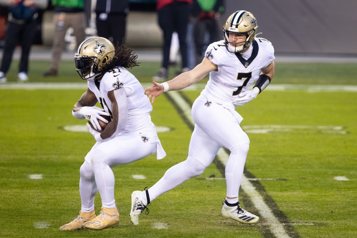 Dec 13, 2020; New Orleans Saints quarterback Taysom Hill (7) hands off to running back Alvin Kamara (41) against the Philadelphia Eagles. Mandatory Credit: Bill Streicher-USA TODAY Sports