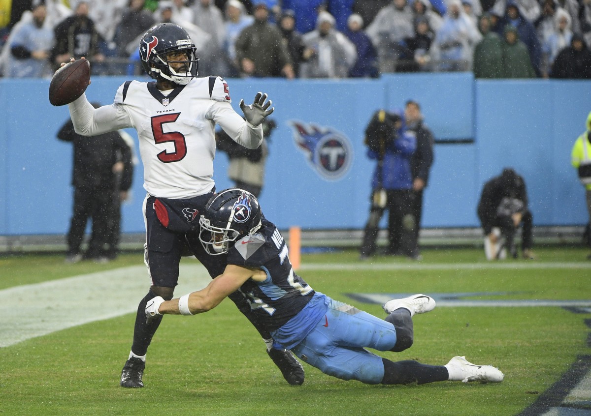 Ex-Husky Elijah Molden hits Houston's Tyrod Taylor.