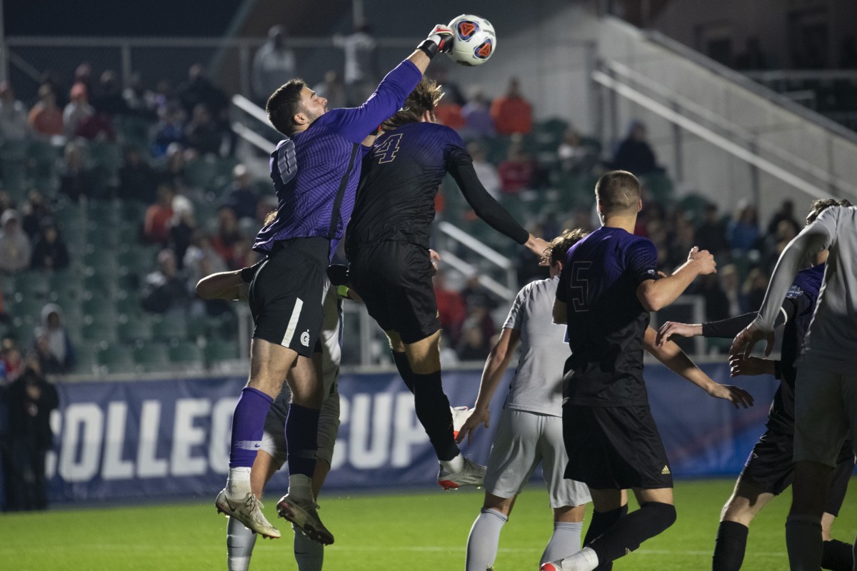 Georgetown keeper Giannis Nikopolidis battles the UW's Ryan Sailor for the ball.