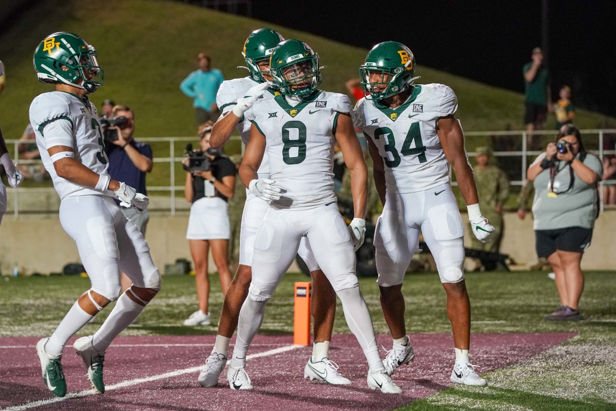 First Team All American safety Jalen Pitre (center, No. 8) celebrates an interception against Texas State in September.