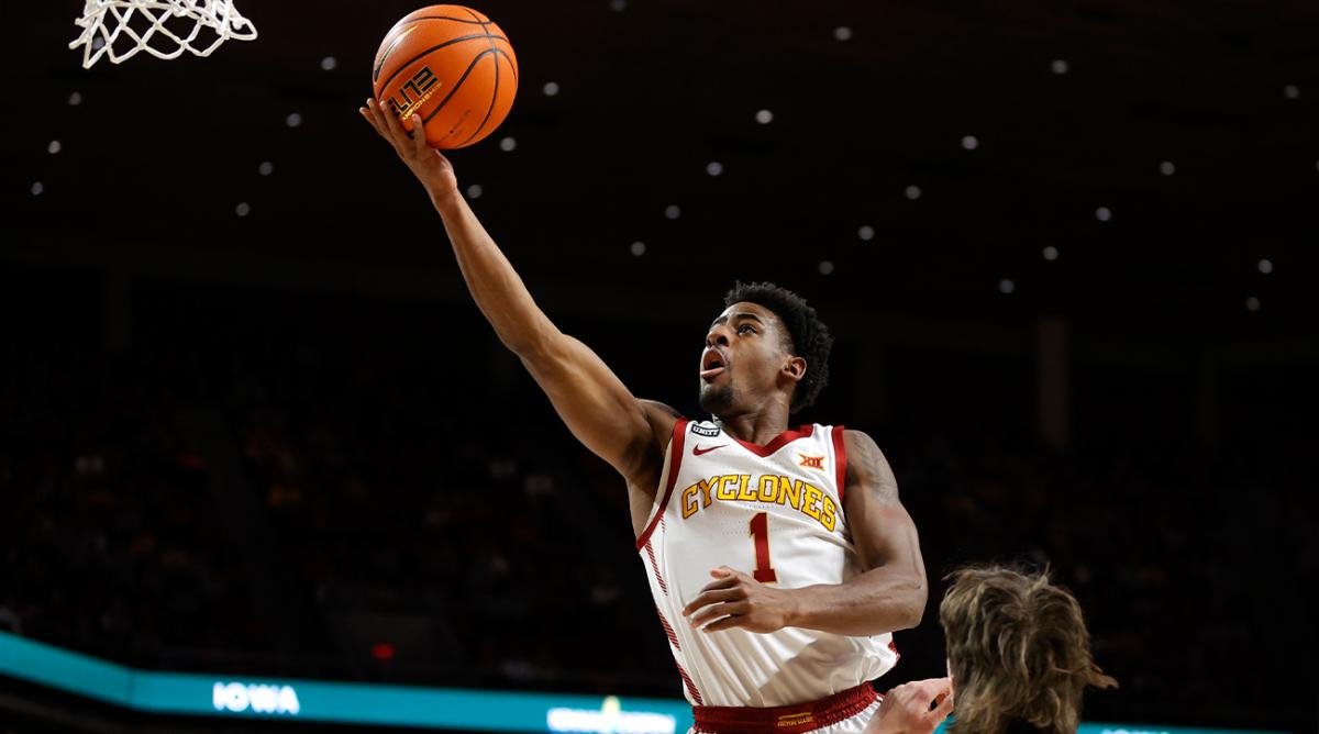 Iowa State guard Izaiah Brockington (1) leaps for a shot over Baylor guard Matthew Mayer (24) during the first half of an NCAA college basketball game, Saturday, Jan. 1, 2022, in Ames.