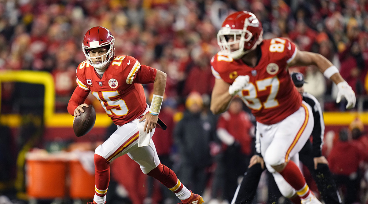 Patrick Mahomes looking to pass the ball while Travis Kelce runs a route.