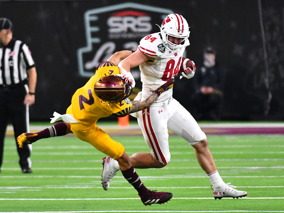 Dec 30, 2021; Paradise, Nevada, USA; Wisconsin Badgers tight end Jake Ferguson (84) looks to break free of the tackle of Arizona State Sun Devils defensive back DeAndre Pierce (2) during the 2021 Las Vegas Bowl at Allegiant Stadium. Mandatory Credit: Stephen R. Sylvanie-USA TODAY Sports