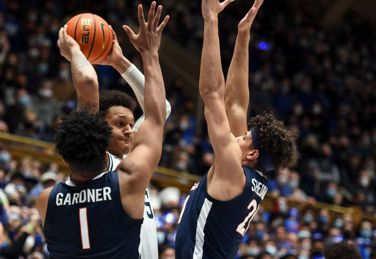 Jayden Gardner and Kadin Shedrick double-team Paolo Banchero during Virginia's 69-68 victory over Duke at Cameron Indoor.