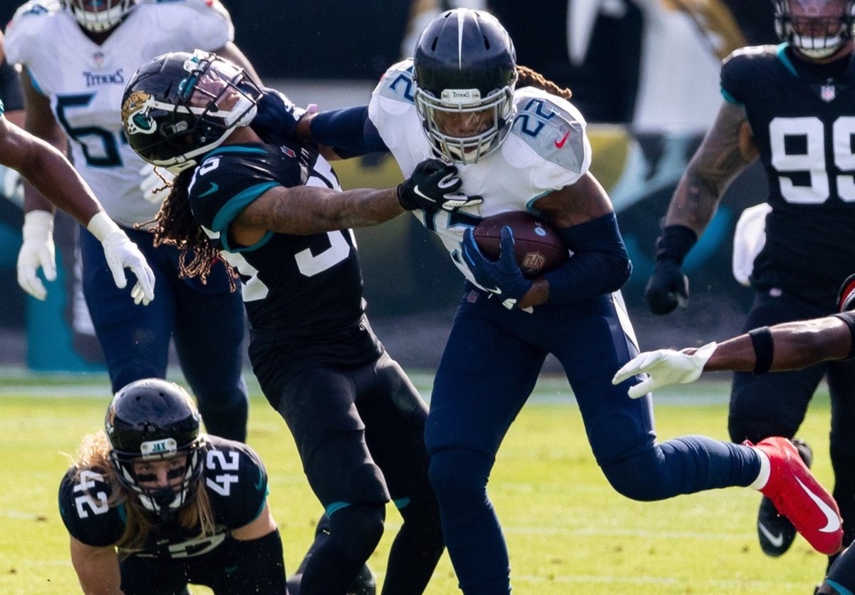 Tennessee Titans running back Derrick Henry (22) stiff arms Jacksonville Jaguars cornerback Sidney Jones (35) in the first quarter during the Jaguars vs. Titans game at TIAA Bank Field in Jacksonville, FL on Sunday, December 13, 2020.