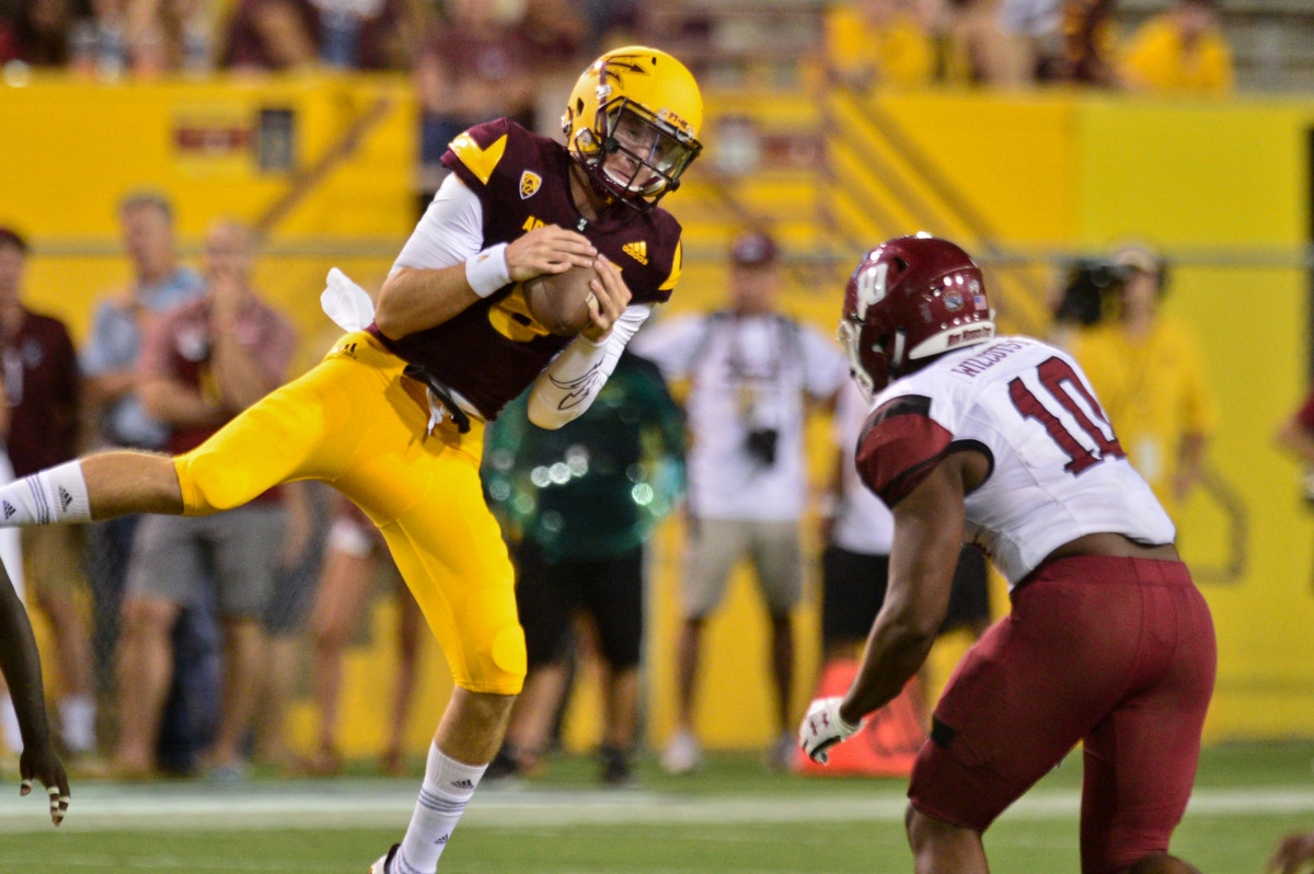 Arizona State Sun Devils quarterback Blake Barnett (8) recovers a high snap just before being sacked by New Mexico State Aggies defensive lineman Cedric Wilcots II (10) during the second half at Sun Devil Stadium.