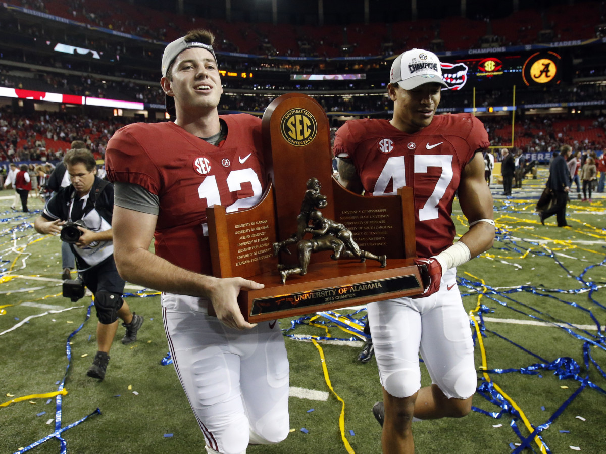 Alabama Crimson Tide quarterback David Cornwell (12) and Christian Miller (47) carry the trophy after the 2015 SEC Championship Game at the Georgia Dome. Alabama won 29-15.