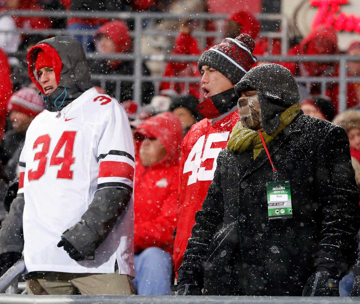 Ohio State Buckeyes fans cheer while snow falls during the third quarter of the the Ohio State Buckeyes and Indiana Hoosiers college football game at Ohio Stadium in Columbus, Ohio on November 23, 2013.