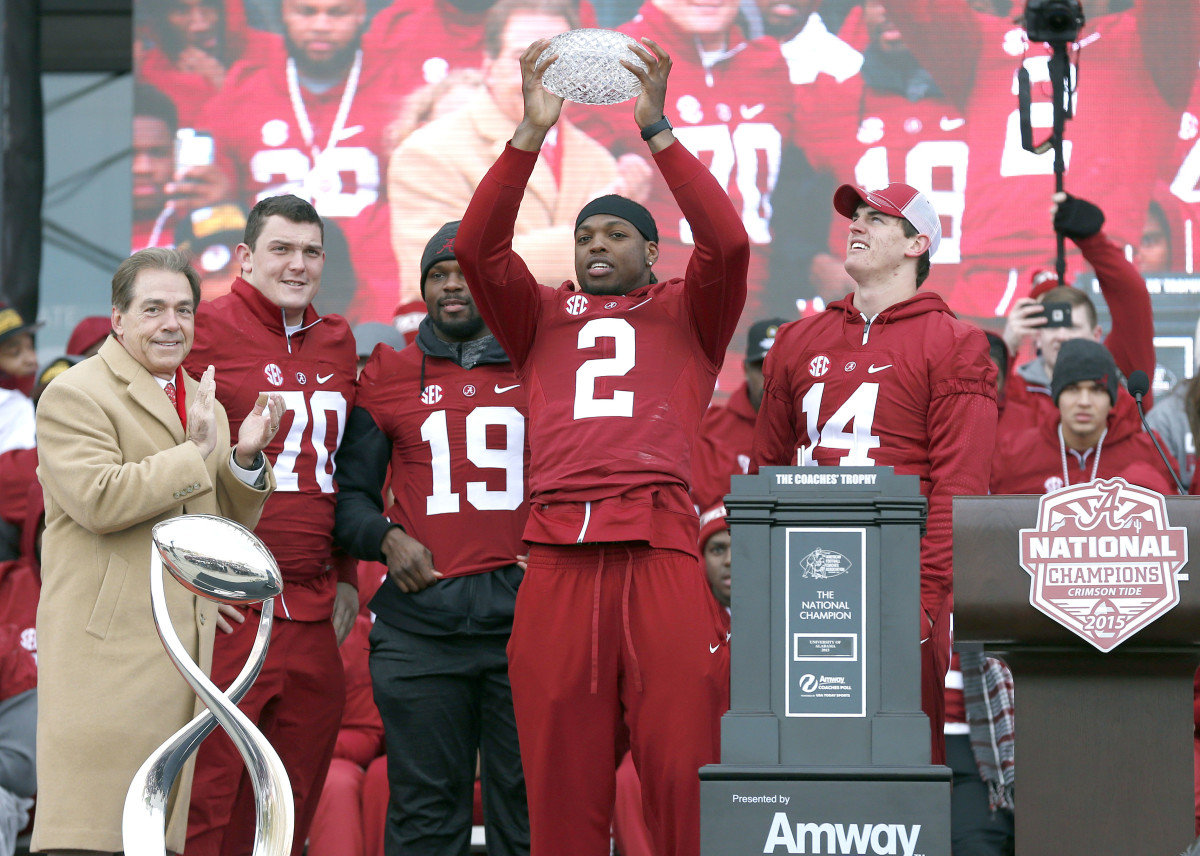 Alabama running back Derrick Henry (2) holds up the Crystal trophy with coach Nick Saban (left), offensive lineman Ryan Kelly (70), linebacker Reggie Ragland (19), and quarterback Jake Coker (14) during a presentation to celebrate the victory in the CFP National Championship game at Bryant-Denny Stadium