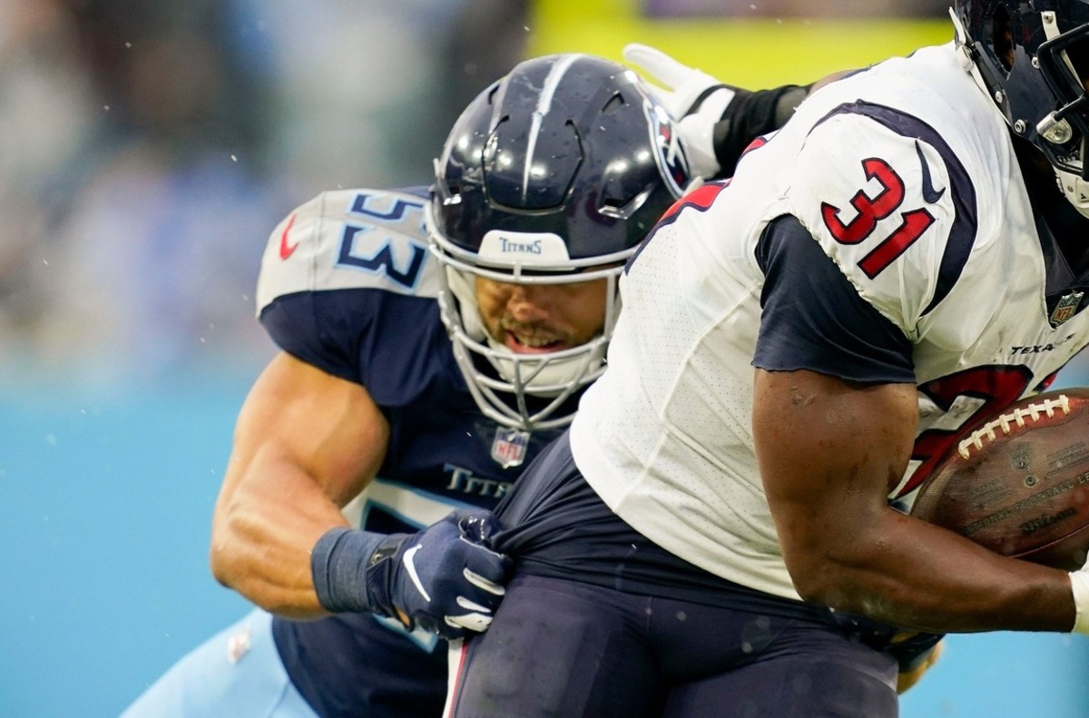 Houston Texans running back David Johnson (31) runs the ball under pressure from Tennessee Titans linebacker Dylan Cole (53) during the second quarter at Nissan Stadium Sunday, Nov. 21, 2021 in Nashville, Tenn.