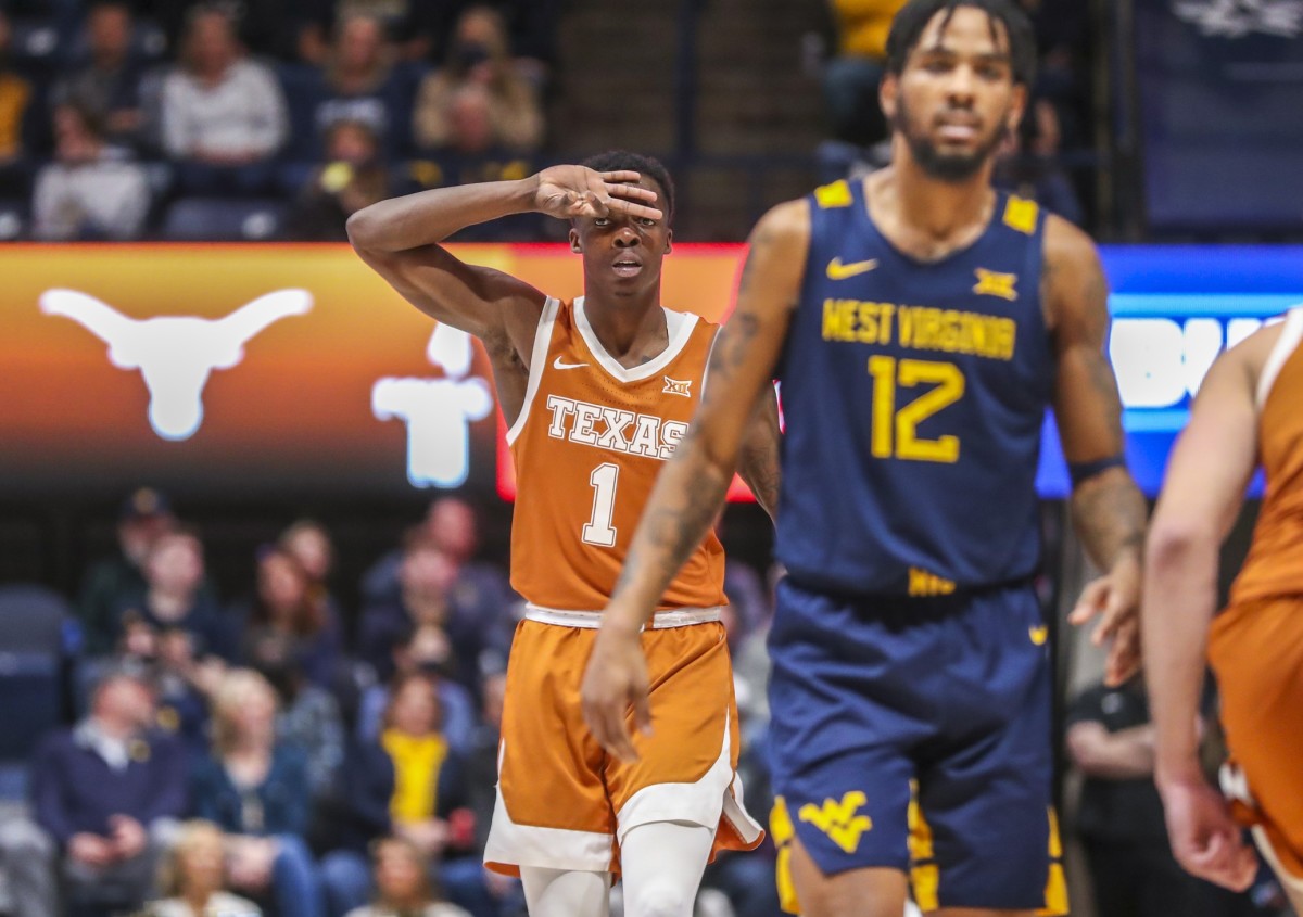 Feb 26, 2022; Morgantown, West Virginia, USA; Texas Longhorns guard Andrew Jones (1) celebrates a made three pointer during the first half against the West Virginia Mountaineers at WVU Coliseum.