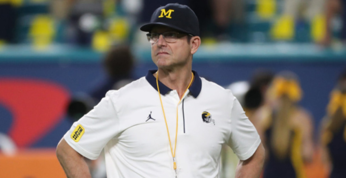 Michigan Wolverines head coach Jim Harbaugh surveys the field before a college football game in the Big Ten.