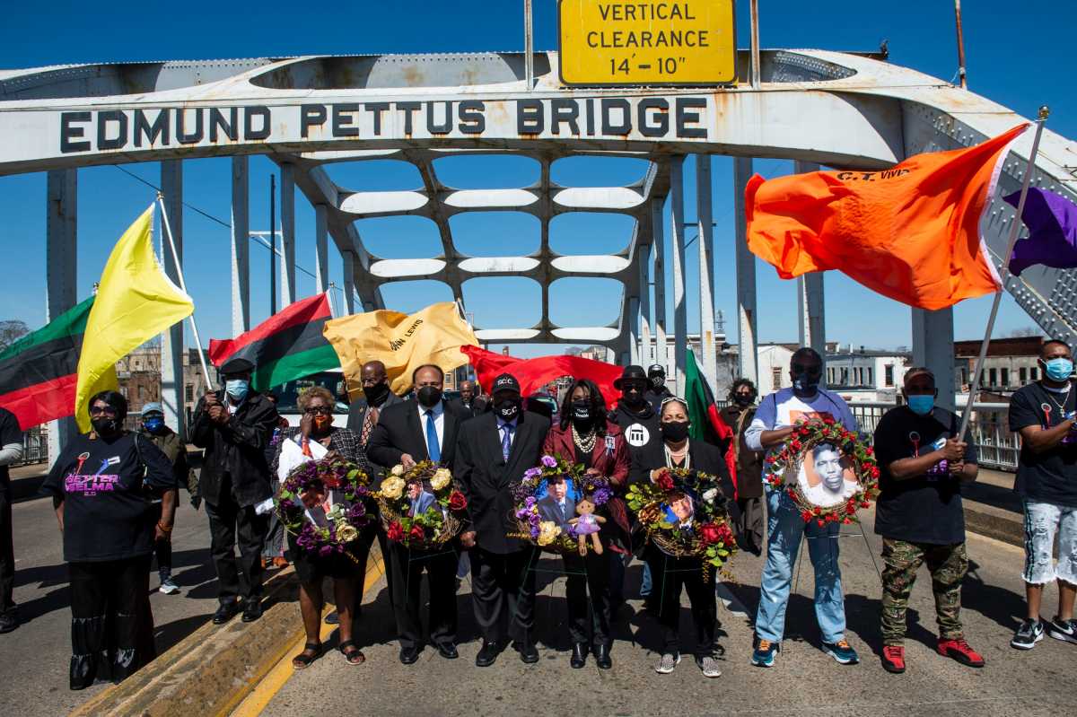 Martin Luther King III, from left, civil rights icon Bernard Lafayette, Rep. Teri Sewell and foot solider Sheyann Webb-Christburg lead the march during the 56th Selma Bridge Crossing Jubilee on the Edmund Pettus Bridge in Selma, Ala., on Sunday, March 7, 2021.