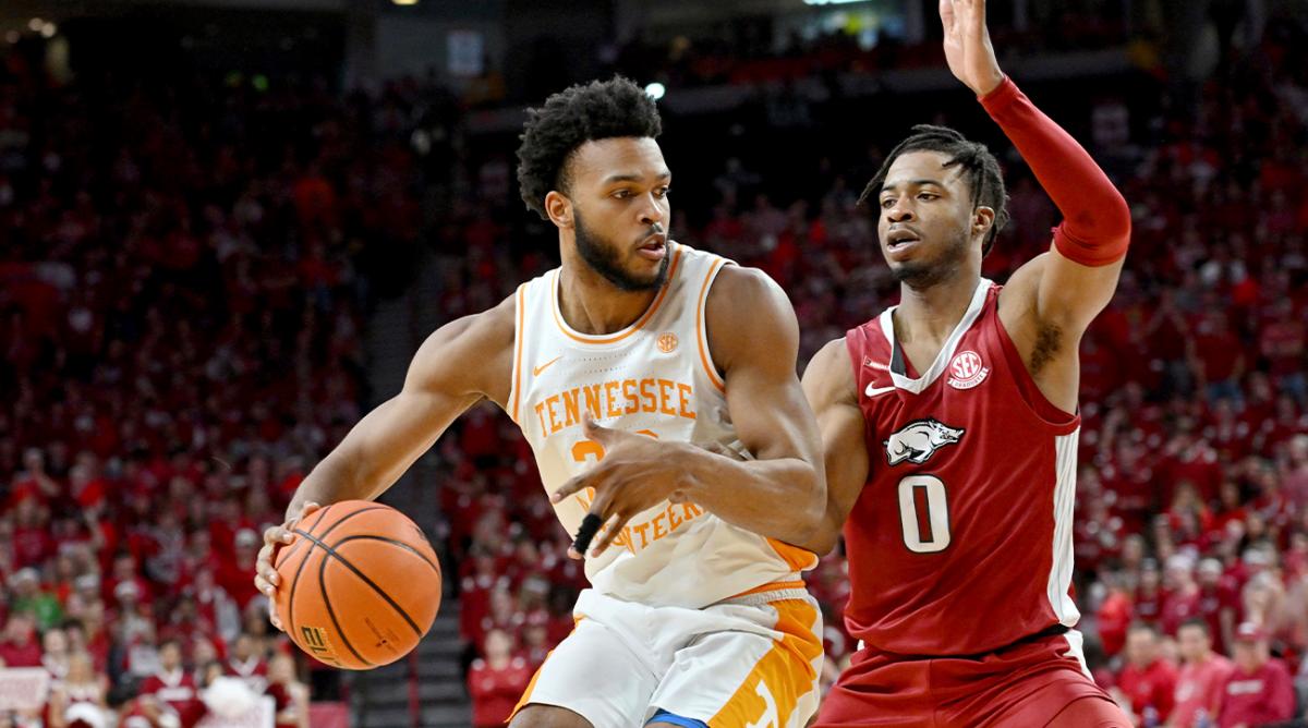 Tennessee guard Josiah-Jordan James, left, tries to get past Arkansas guard Stanley Umude (0) during the second half of an NCAA college basketball game Saturday, Feb. 19, 2022, in Fayetteville, Ark.