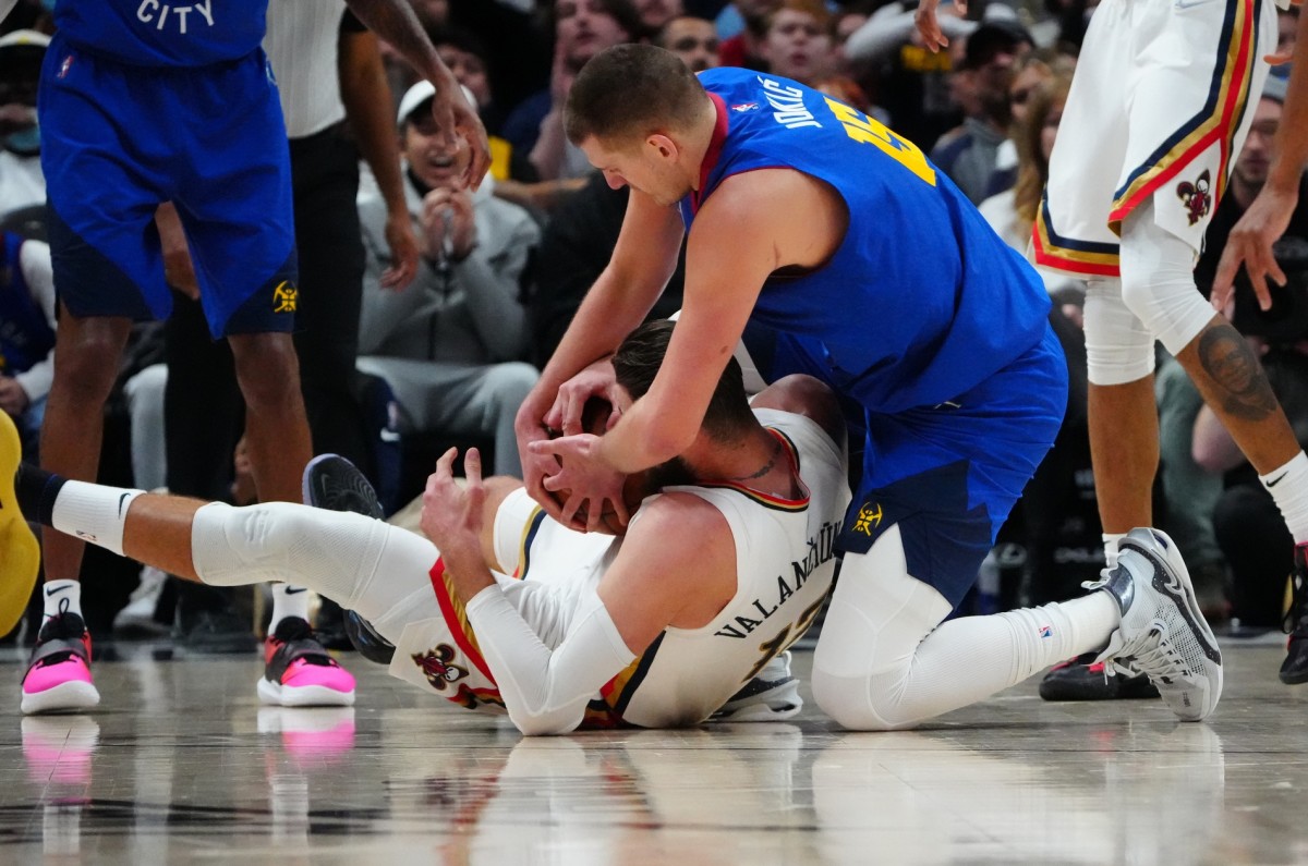 New Orleans Pelicans center Jonas Valanciunas (17) and Denver Nuggets center Nikola Jokic (15)